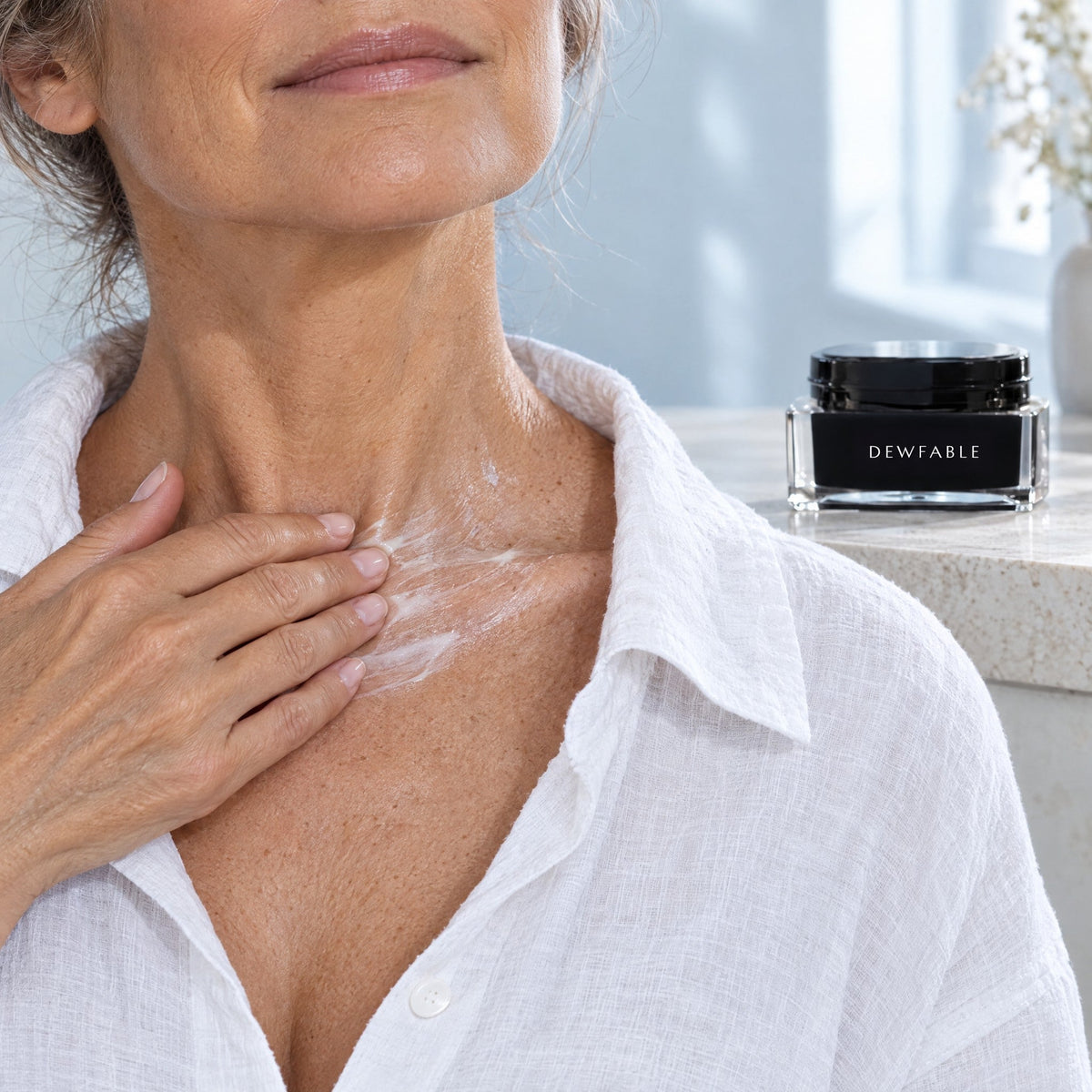 Woman smoothing Shea Body Butter across her collarbone