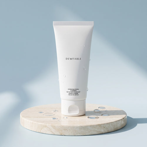 Hydrating Facial Cleanser tube on a pale stone plinth