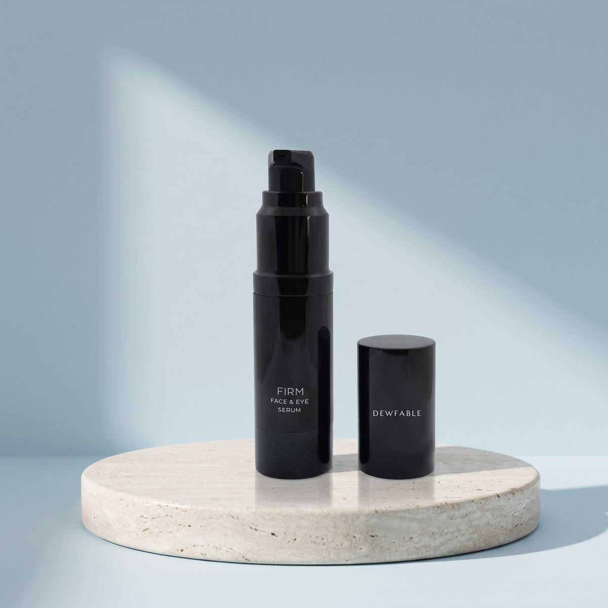 Firm Face & Eye Serum and its cap on a pale stone plinth
