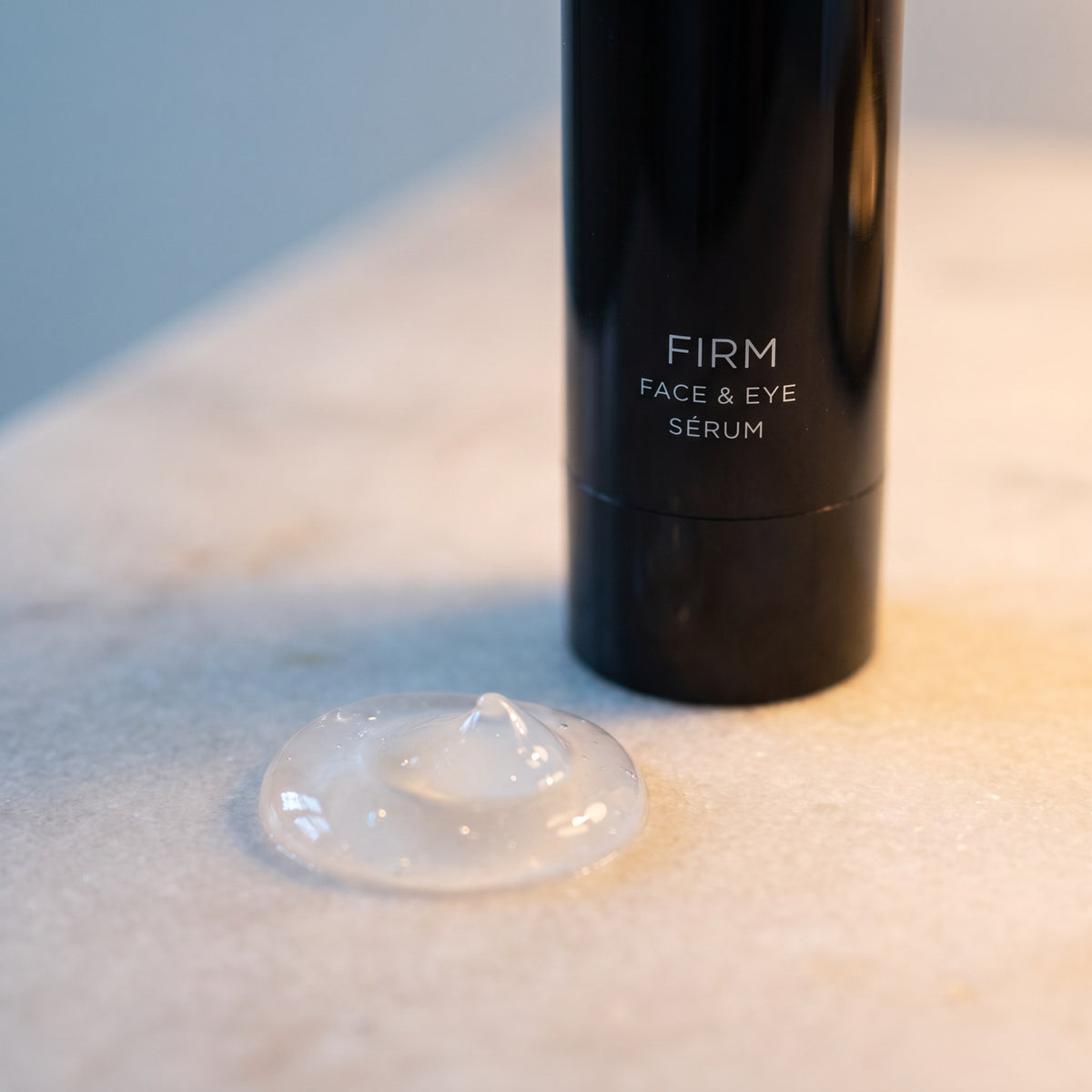 A swirl of clear Firm Face & Eye Serum gel