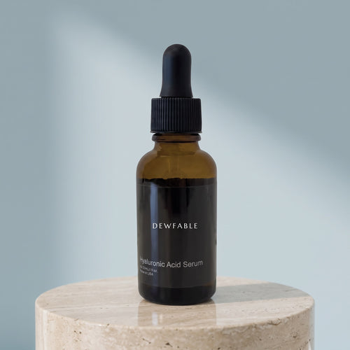 Hyaluronic Acid Serum on a pale stone plinth