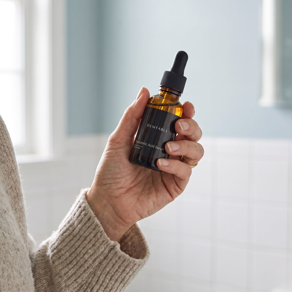 Holding the Hyaluronic Acid Serum bottle