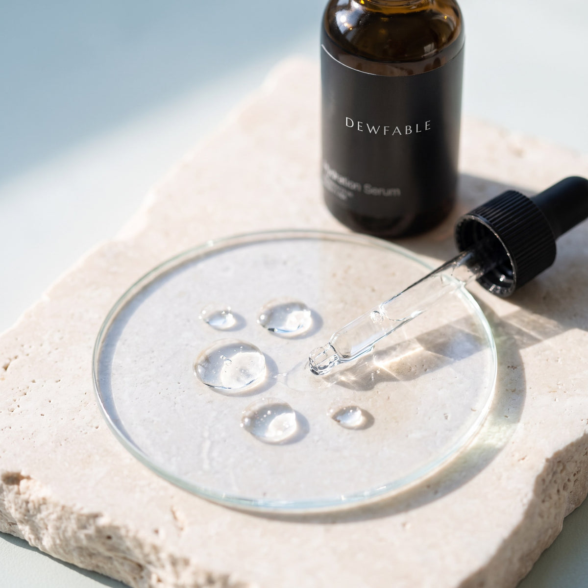 Clear drops of Hydration Serum on glass
