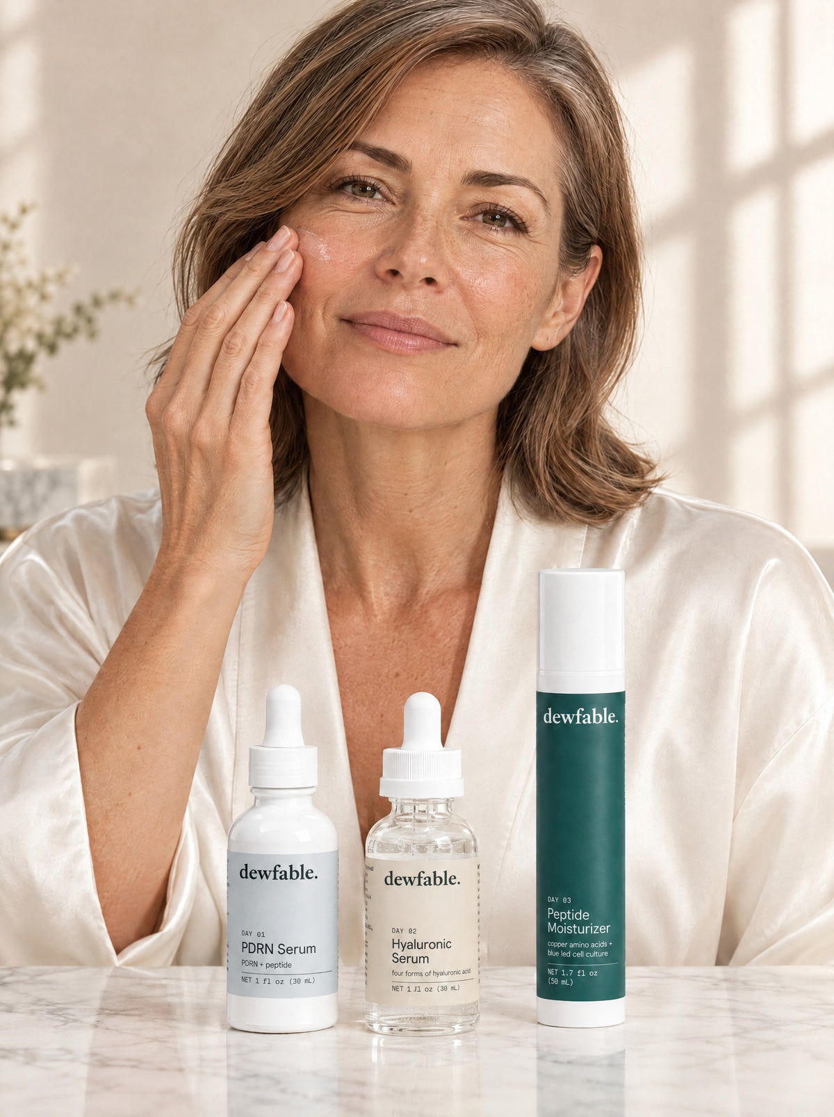 A woman in her fifties at her vanity with the three dewfable. day steps