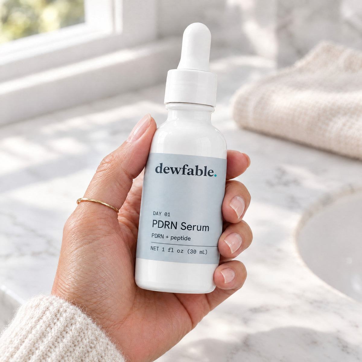 dewfable. PDRN Serum, held in a hand